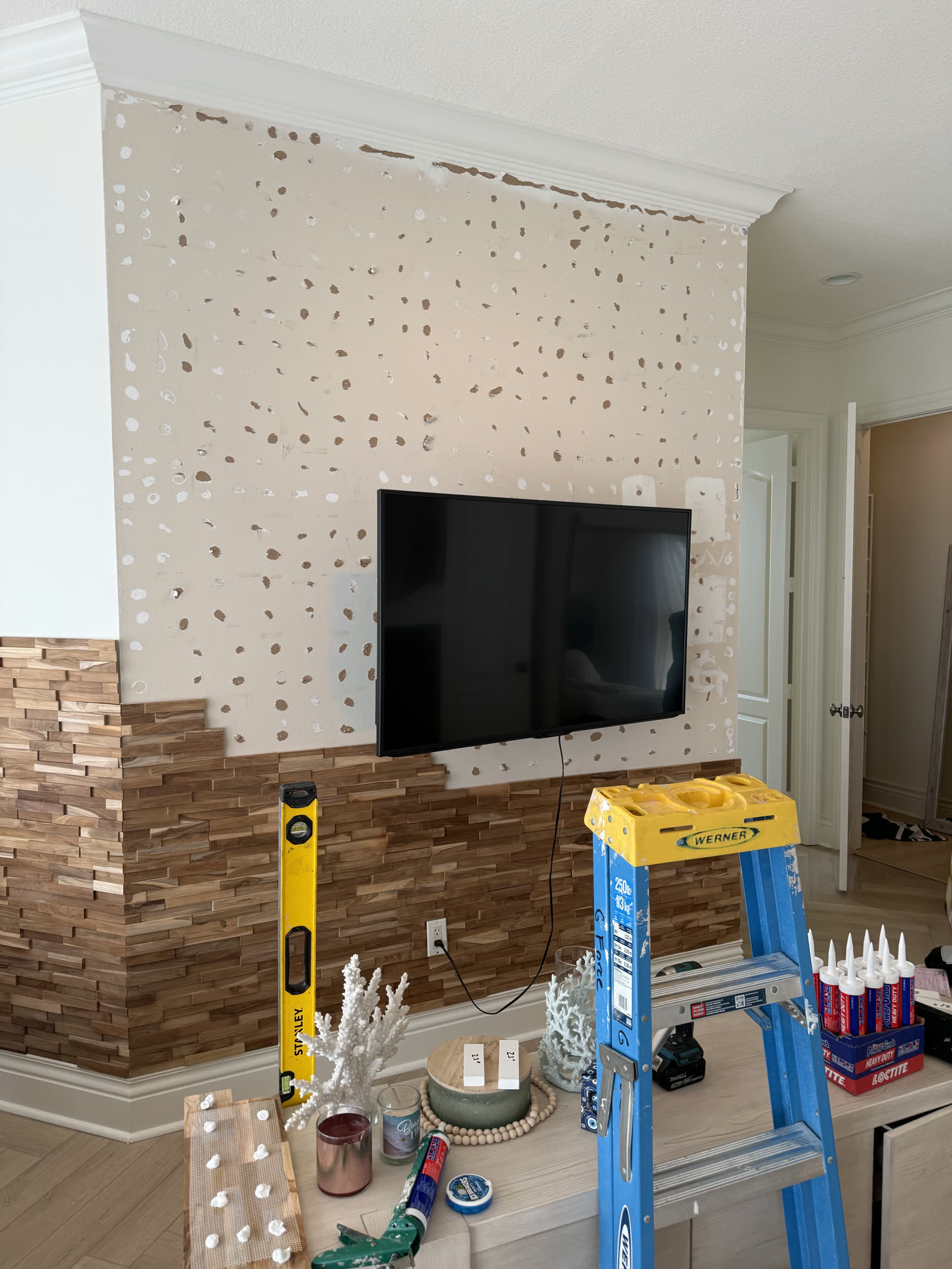 Patched-drywall wall before teak accent installation