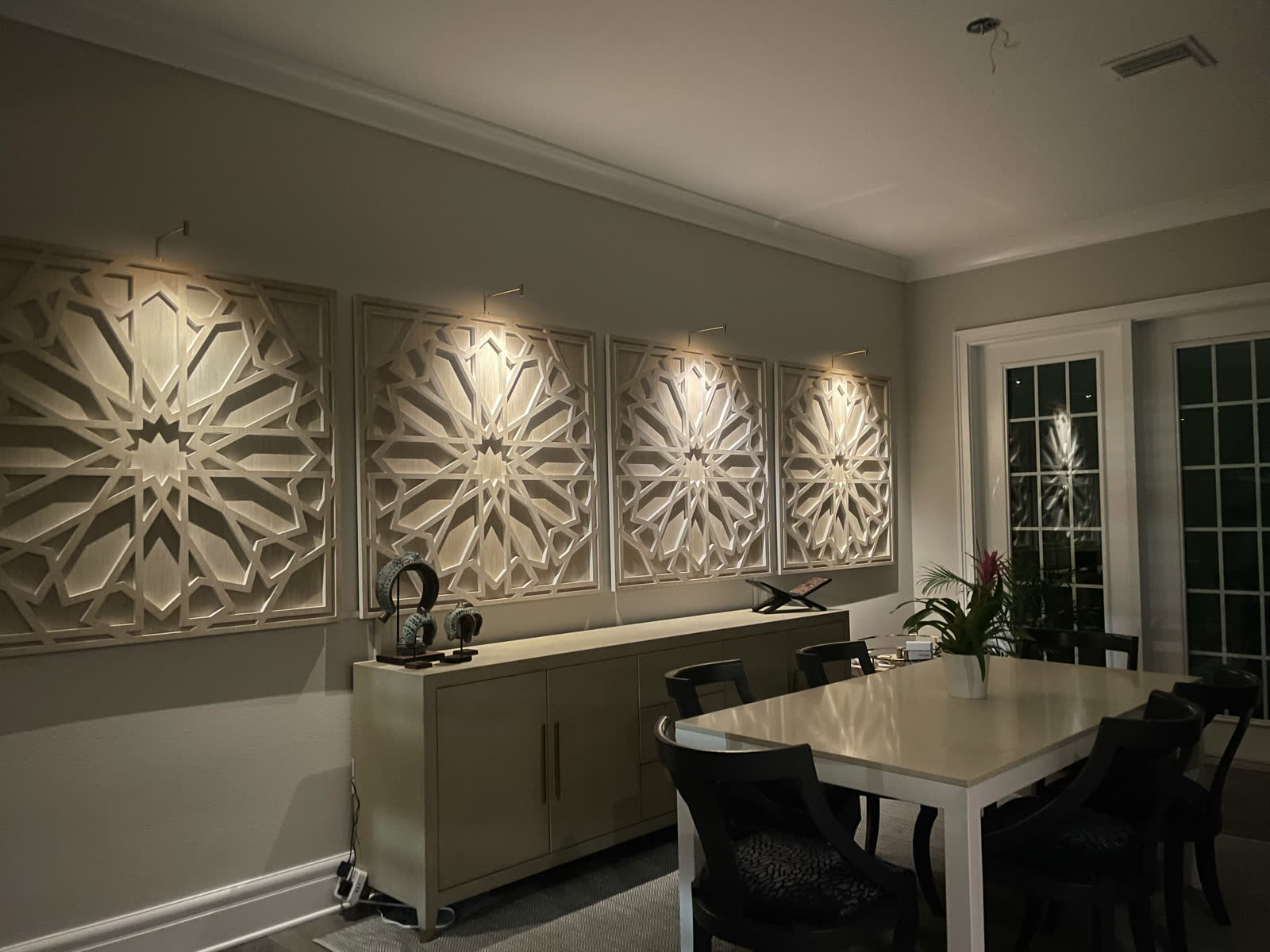 Finished dining room with four custom-lit decorative wall panels